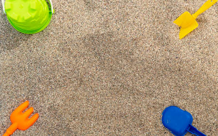 Plastic childrens toys in the sand. Concept of family vacation. Top view. Space for text.の写真素材