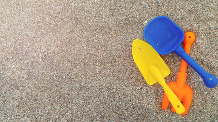 Plastic childrens toys in the sand. Concept of family vacation. Top view. Space for text.の写真素材
