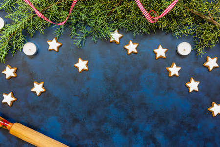 Stylish Christmas composition, coniferous tree and cookies on bleu vintage stone background. Top...
