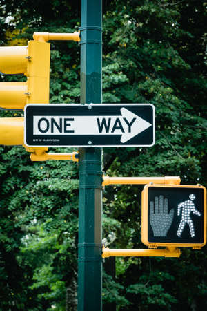 New York City road sign One Way with traffic pedestrian light on the street in Manhattan. Urban city lifestyle photoの写真素材
