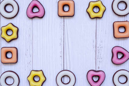 Assorted sweets frame on white wooden background. Top view, copy space for for your greetings.