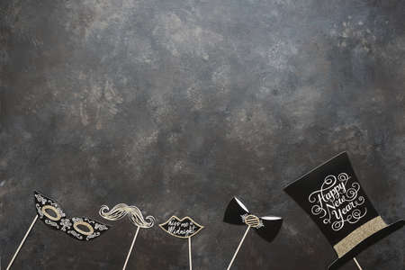 New year and Christmas party props accessories on dark vintage background. Happy new year 2020 party celebration and holiday concept.の写真素材