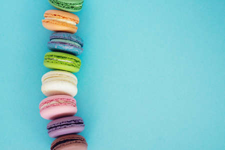 Colourful french macarons on pastel background. Sweet concept.の写真素材