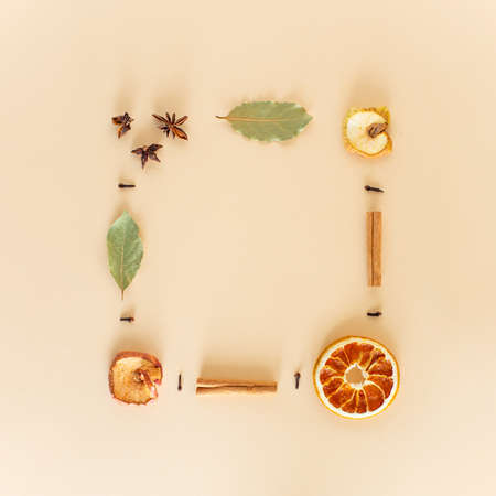 Winter composition of dried fruits and spices with the scent of Christmas holidays. Minimal frame flat lay. Space for your design. Christmas or New Year concept.の写真素材