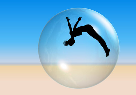 Beach Ball- Silhouette of an acrobatic woman seen through a beach ball on the sand.