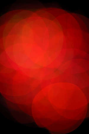 Abstract blurred macro image of lighted red christmas tree bulbs.の写真素材