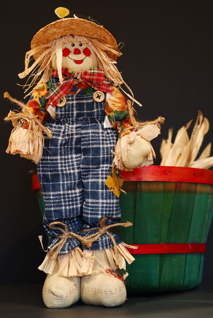 Scarecrow and green fall basket.の写真素材