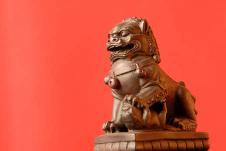 Chinese Foo Dog - A female fu dog has a single cub under her left paw and protects those dwelling inside their home.の写真素材