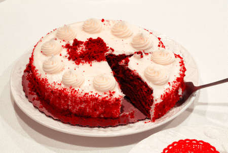 Red Velvet Chocolate Cake - Close up of a Red Velvet Chocolate Cake birthday cake and a slice on a server.birthday, cake, sweets, frosting, icing, baked, baker, bakery, celebration, celebrate, tradition, food, flatware, utensils, red, white, plate, sliceの写真素材
