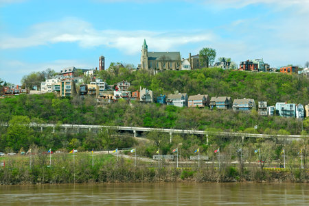 Holy Cross Immaculata Church sits atop Mt Adams, as seen from across the Ohio River in Kentucky.  Nestled high above downtown Cincinnati and the beautiful Ohio River, for over 200 years, historic Mt. Adams has shared a rich and fascinating history with thの写真素材