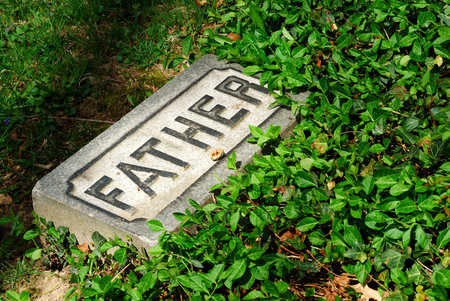 Here Lies My Father - A stone with the word father etched in it at an historic  1800s cemetery.の写真素材