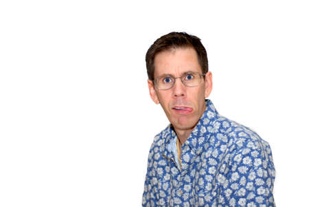 A man sticking out his tongue and making a crazy facial expression.