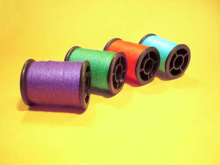 Colorful reel wires over a yellow background
