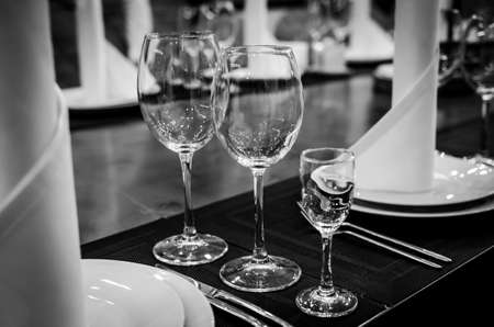 Empty glasses in restaurant. Table setting for dinnerの写真素材