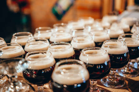 Set of glasses of dark beer in pub or restaurant. Degustation set at the festivalの写真素材