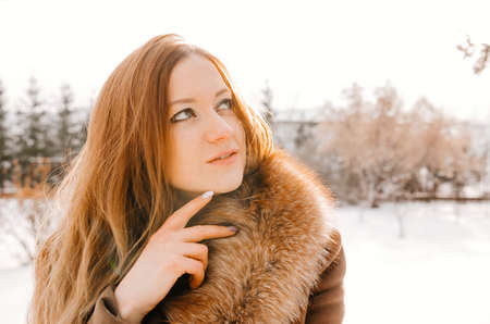 Gorgeous ginger woman in winter parkの写真素材