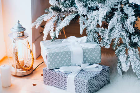 Christmas tree with gifts and beautiful flashlight. Winter holiday concept