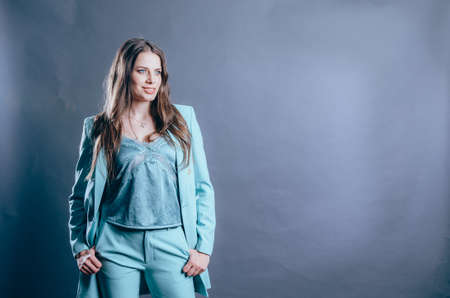 Attractive woman dressed in a light blue jacket. Women's business suits concept
