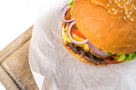 Closeup of home made beef burger on a wooden board. Space for textの写真素材