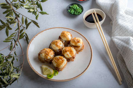 Top view on the plate of baked rolls with sauce