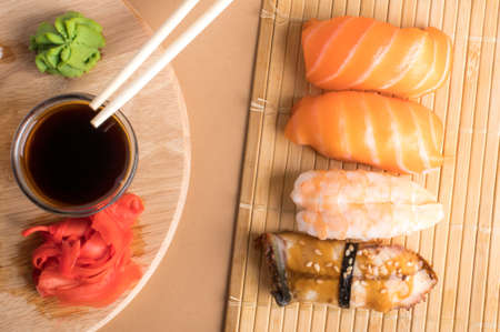 Assorted sushi set served on bamboo mat. Top view on a light backgroundの写真素材