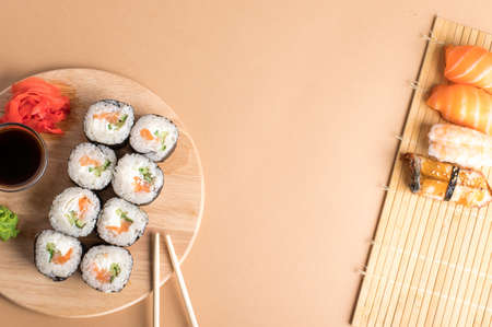 Sushi set sashimi with salmon, shrimp, eel and sushi rolls served on bamboo mat and wooden board. Copy spaceの写真素材