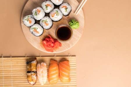 Sushi set sashimi with salmon, shrimp, eel and sushi rolls  served on bamboo mat and wooden board. Copy spaceの写真素材