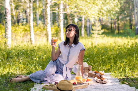 Outdoor portrait young beautiful woman resting on the grass in parkの写真素材