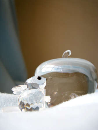 a crystal mouse going to eat an grass appleの写真素材