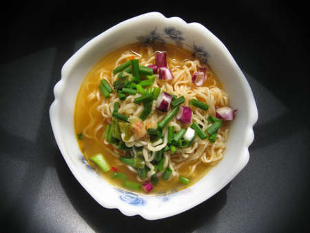 a top view for a bowl of instant noodles with spring onion dressingの写真素材