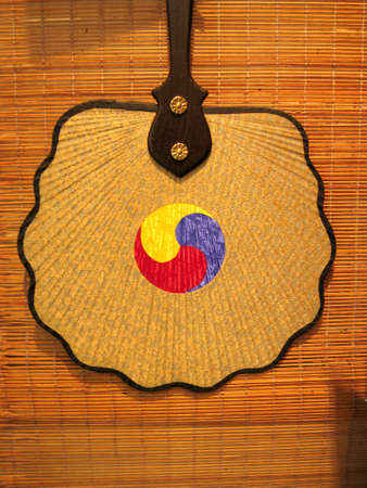 a traditional korean fan hanging on a wallの写真素材