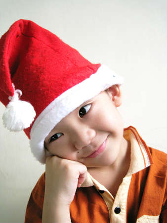 A asian boy wearing a santa hat with face expressionの写真素材