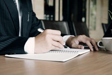 Close up business man signing contract making a deal with business partnerの写真素材