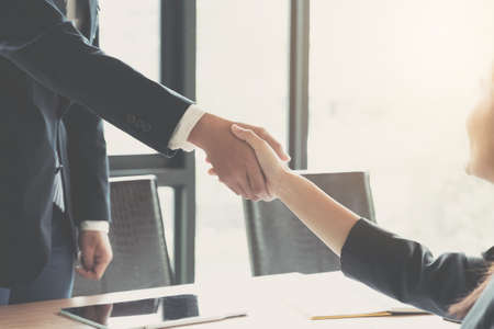 Close up of Business people shaking hands, finishing up meeting, business etiquette, congratulation,...