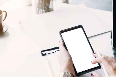 Top view Woman sitting and holding blank screen mock up mobile phone
