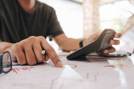 businessman working with calculator for financial document in office. male accountant doing accounting and calculating. bookkeeper making calculation. Savings, financeの写真素材
