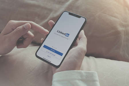 CHIANG MAI, THAILAND, APR 06 2020  : A women holds Apple iPhone Xs with LinkedIn application on the screen.LinkedIn is a photo-sharing app for smartphones.のeditorial素材