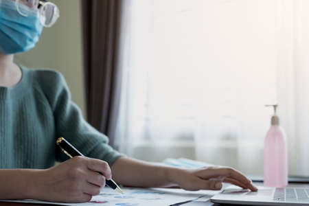 Coronavirus. Business women wear masks to protect and take care of their health. Home working with...