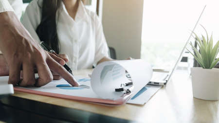 Close up Businessman using calculator and laptop for do math finance on wooden desk in office and business working background, tax, accounting, statistics and analytic research conceptの写真素材