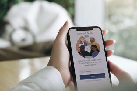 CHIANG MAI, THAILAND - JUL 25 2020 : A working from home employee is downloading the Microsoft Teams social platform, ready for remote working in isolation from homeのeditorial素材