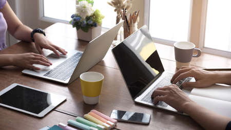 Blank screen Laptop computer and poster workspace background in modern office.