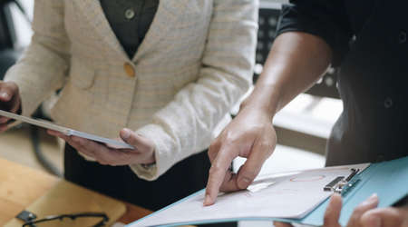 Manager and employee interview concept with handshake after talking about contract signing.