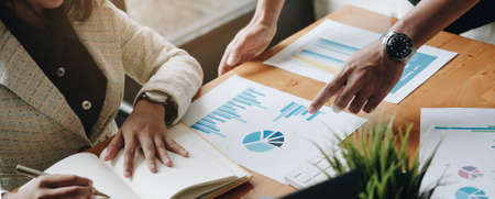 Manager and employee interview concept with handshake after talking about contract signing.