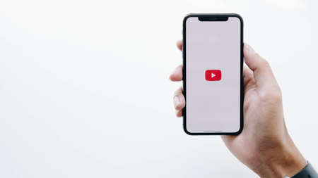 CHIANG MAI ,THAILAND FEB 16 2020 : Woman holding a iPhone X or iPhone 10 with social Internet service Youtube on the screenのeditorial素材