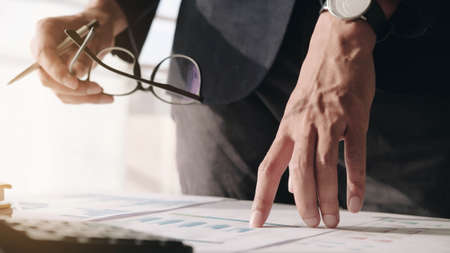 Close up of Businessman investment consultant analysis company annual financial report balance sheet...
