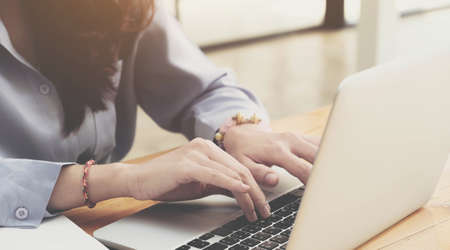 Photo of girl sit table computer hold  coffee and  write diary  in living room home indoors.