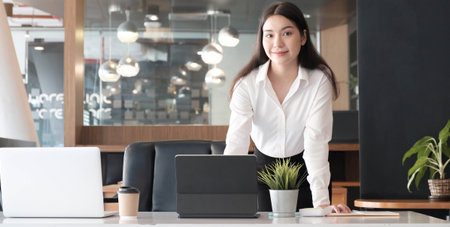 Business woman using laptop for do math finance on wooden desk in office and business working...