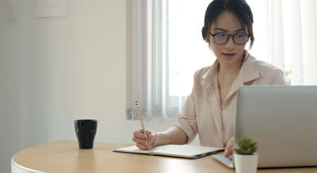 Woman using mobile smart phone online banking with Credit card money transfer successful filling in billing information in laptop purchasing products on ecommerce store payment shopping transactionの写真素材