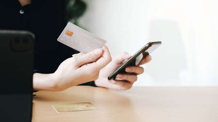 Hands holding credit card and using laptop. Online shoppingの写真素材