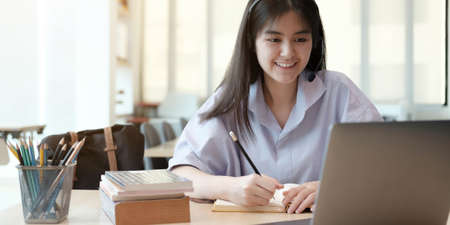 Young girl showed hands successful to her friends on a video call on laptop in the home....